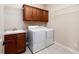 A well-appointed laundry room with cabinets, sink, and modern washer and dryer at 1837 Haven Park Se Cir, Smyrna, GA 30080