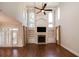 Bright living room boasts a fireplace, built-in shelves, tall windows, and sleek hardwood floors for modern appeal at 1837 Haven Park Se Cir, Smyrna, GA 30080