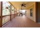 This covered porch has three ceiling fans, decorative hanging plants, and wood floor at 1837 Haven Park Se Cir, Smyrna, GA 30080