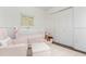 Bedroom featuring a crib, comfortable armchair, closet, and decorative accents at 2038 Drogheda Ln, Marietta, GA 30066