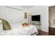 Bright bedroom with large closet, decorative ladder, television, and tray on bed at 2038 Drogheda Ln, Marietta, GA 30066