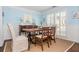 Bright dining room with a wooden table, white trim, light blue walls and large shuttered window at 2038 Drogheda Ln, Marietta, GA 30066