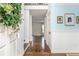 Light-filled foyer with hardwood floors, crisp molding, light blue accent wall and staircase at 2038 Drogheda Ln, Marietta, GA 30066