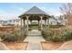 Beautiful gazebo overlooking serene backyard with lush landscaping and surrounding trees at 2038 Drogheda Ln, Marietta, GA 30066