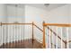 Hallway landing featuring wood railing and floors with a chandelier providing light at 2038 Drogheda Ln, Marietta, GA 30066