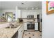 Bright kitchen with stainless steel appliances and granite countertops at 2038 Drogheda Ln, Marietta, GA 30066