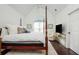 Spacious main bedroom with a four-poster bed, vaulted ceilings, and an abundance of natural light at 2038 Drogheda Ln, Marietta, GA 30066