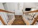 An overhead view down the stairway showcasing the home's wood flooring and white railing at 2038 Drogheda Ln, Marietta, GA 30066
