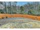 Fenced backyard with stone patio, mature trees, and basketball hoop at 2730 Henderson Chase Ct, Tucker, GA 30084