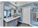 Bright bathroom featuring a single sink vanity, large mirror and walk-in closet at 2730 Henderson Chase Ct, Tucker, GA 30084