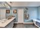 Modern bathroom with a soaking tub, single sink vanity, and stylish decor at 2730 Henderson Chase Ct, Tucker, GA 30084