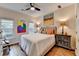 Well-lit bedroom with hardwood floors and decorative wall art above bed and furniture at 2730 Henderson Chase Ct, Tucker, GA 30084