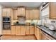 Charming kitchen with stainless appliances, black countertops, and light wood cabinets at 2730 Henderson Chase Ct, Tucker, GA 30084