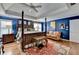 Stylish main bedroom boasts dark blue walls and hardwood floors plus sitting area at 2730 Henderson Chase Ct, Tucker, GA 30084