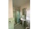 Retro bathroom featuring a stall shower, pedestal sink, and medicine cabinet at 3702 Chesapeake Way, Atlanta, GA 30344