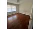 Bright bedroom features hardwood flooring, a ceiling fan, and natural light from a large window at 3702 Chesapeake Way, Atlanta, GA 30344