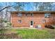 Backyard view of red brick home with an air conditioning unit outside at 3702 Chesapeake Way, Atlanta, GA 30344