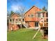 Inviting backyard features an elevated deck, lush lawn and mature trees offering privacy and outdoor enjoyment at 610 Coolsprings Ln, Woodstock, GA 30188