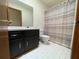 Bathroom with large vanity, black cabinets, and white tile floors at 610 Coolsprings Ln, Woodstock, GA 30188