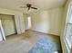 Comfortable bedroom with neutral carpet, ceiling fan, a closet, and a bright window at 610 Coolsprings Ln, Woodstock, GA 30188