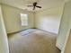 Simple bedroom with neutral carpet, ceiling fan, a closet, and a window with natural light at 610 Coolsprings Ln, Woodstock, GA 30188