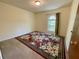 Carpeted bedroom featuring a window, rug, and neutral wall color at 610 Coolsprings Ln, Woodstock, GA 30188