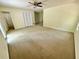 Spacious bedroom featuring neutral carpet, ceiling fan, a closet, and plenty of room at 610 Coolsprings Ln, Woodstock, GA 30188
