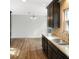 Galley kitchen features granite counters, stainless sink, and dark cabinets at 610 Coolsprings Ln, Woodstock, GA 30188