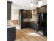 Modern kitchen features stylish dark cabinets, stainless steel appliances, and a light wood floor at 610 Coolsprings Ln, Woodstock, GA 30188