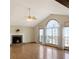 Bright living room with a stone fireplace, vaulted ceiling, and large windows offering plenty of natural light at 610 Coolsprings Ln, Woodstock, GA 30188