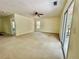 Open living area with neutral carpet, ceiling fan, and sliding glass doors to the outside at 610 Coolsprings Ln, Woodstock, GA 30188