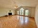 Large living room with a vaulted ceiling, fireplace, large windows, and hardwood floors at 610 Coolsprings Ln, Woodstock, GA 30188
