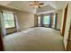 Spacious main bedroom with tray ceiling, neutral carpet, and many windows at 610 Coolsprings Ln, Woodstock, GA 30188
