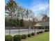 Fenced in-ground pool ready for summer fun and surrounded by lush greenery for extra privacy at 610 Coolsprings Ln, Woodstock, GA 30188