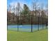 Fenced in tennis court with blue surface is ready for practice or competition at 610 Coolsprings Ln, Woodstock, GA 30188