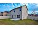 A spacious backyard featuring a well-maintained lawn and a neutral-colored two-story home with classic windows at 11978 Quail Rd, Hampton, GA 30228