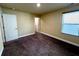 Bedroom featuring neutral-colored walls, plush carpeting, and a window with blinds for natural light at 11978 Quail Rd, Hampton, GA 30228