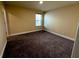 Bedroom features neutral walls, plush carpeting, and a window providing natural light at 11978 Quail Rd, Hampton, GA 30228