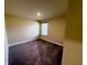 Bedroom with a window and neutral-colored walls and carpet at 11978 Quail Rd, Hampton, GA 30228