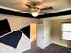 Modern bedroom with unique black geometric accents, tray ceiling, and ceiling fan at 11978 Quail Rd, Hampton, GA 30228