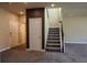 Inviting entryway featuring a staircase with carpeted steps and an adjacent closet door for convenient storage at 11978 Quail Rd, Hampton, GA 30228