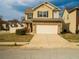 Two-story home featuring a two-car garage and well-maintained front yard at 11978 Quail Rd, Hampton, GA 30228
