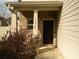 Close up of the home's front door with brick facade and manicured landscaping at 11978 Quail Rd, Hampton, GA 30228