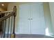Hallway with double doors and access to upper floor at 11978 Quail Rd, Hampton, GA 30228