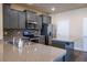 Close up of a kitchen with grey cabinets, stainless steel appliances, and granite countertops at 11978 Quail Rd, Hampton, GA 30228