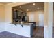 A well-lit kitchen featuring gray cabinets, an island, and stainless steel appliances, creating an appealing cooking space at 11978 Quail Rd, Hampton, GA 30228