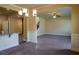 Bright living room showcasing neutral walls, a staircase, and seamless flow into the kitchen area at 11978 Quail Rd, Hampton, GA 30228