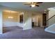 Spacious living room flows into dining area, with stylish light fixture and adjacent kitchen bar at 11978 Quail Rd, Hampton, GA 30228