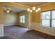 Open-concept living and dining area with neutral walls, decorative molding, and large windows for ample natural light at 11978 Quail Rd, Hampton, GA 30228