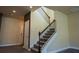 Carpeted staircase with wooden handrail leads to the upper level, complemented by neutral wall colors at 11978 Quail Rd, Hampton, GA 30228